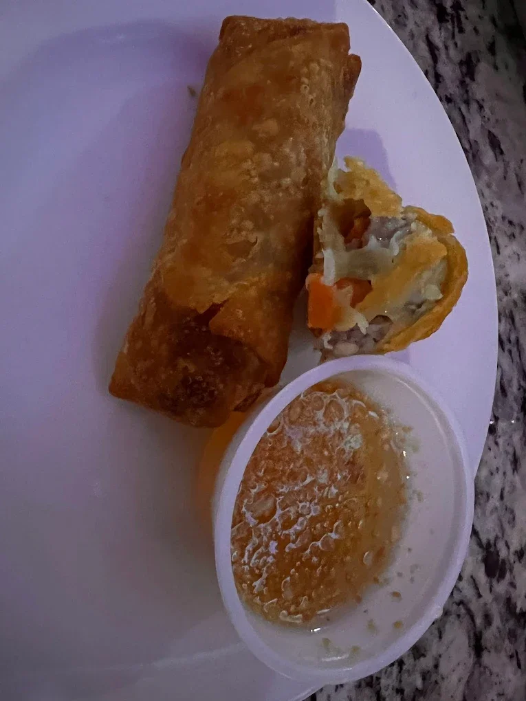 Spring Roll with Peanut Sauce - Crispy golden spring rolls served with our signature sweet peanut dipping sauce